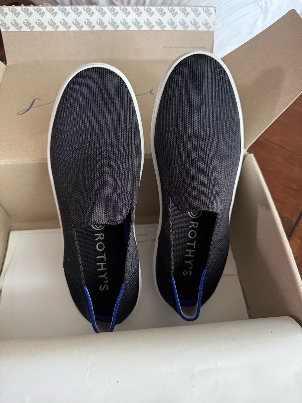 Rothy's Black Slip-On Sneakers with Blue Heel Loop